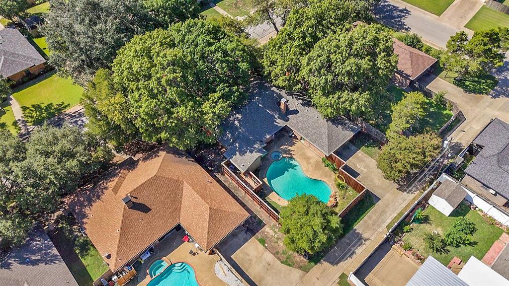 an aerial view of a house with a yard and potted plants