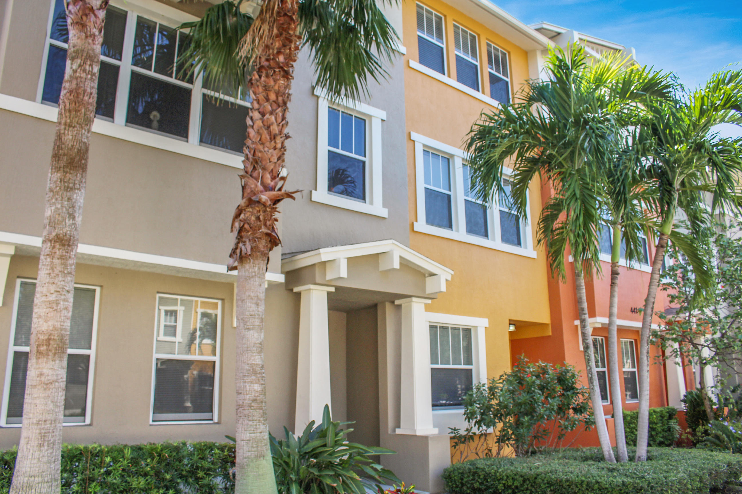 a front view of a multi story residential apartment building with a yard