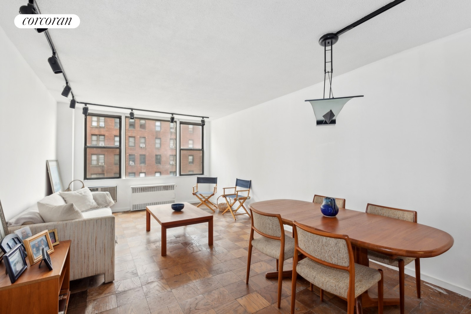 a living room with furniture and a floor to ceiling window