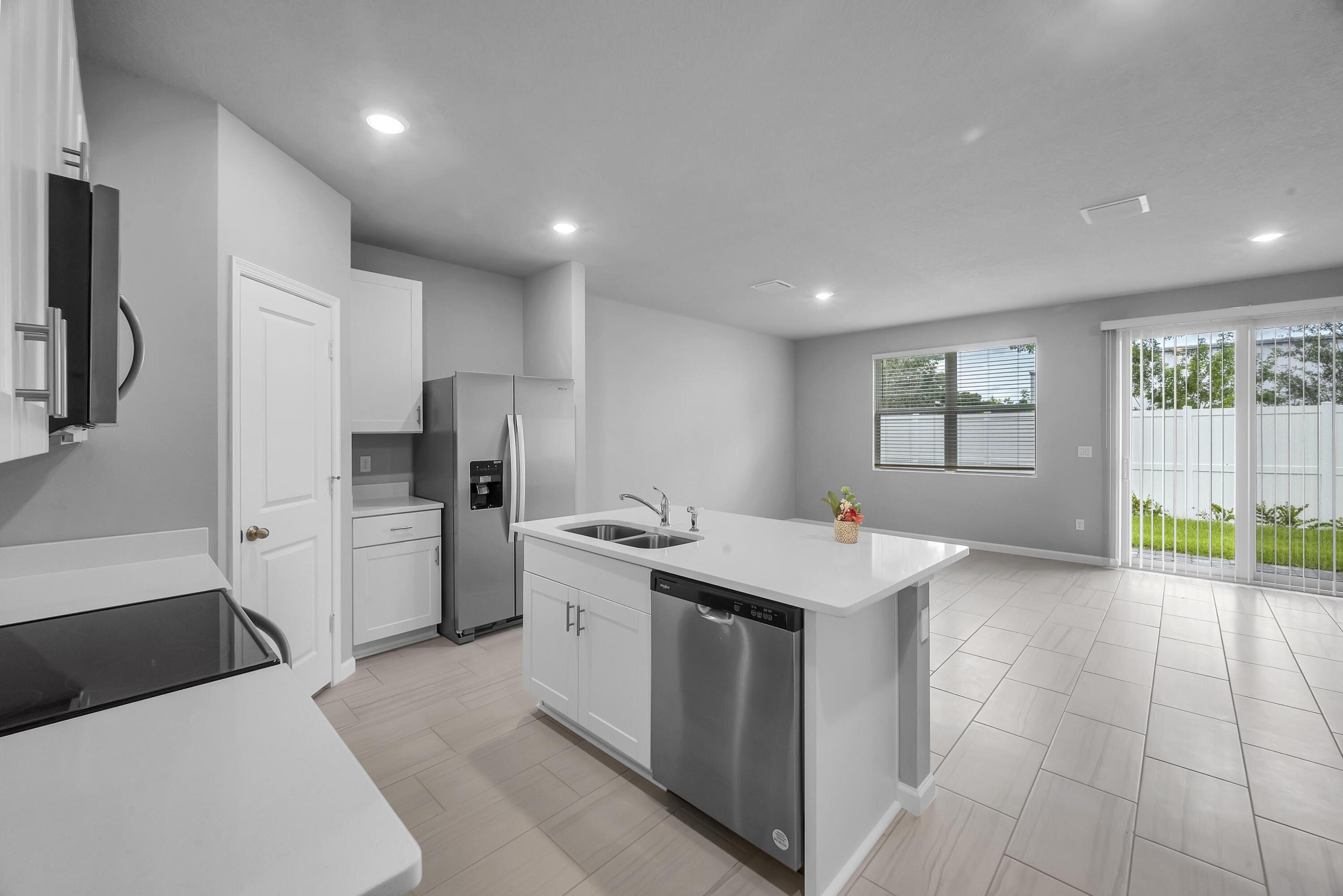 a kitchen that has a lot of cabinets in it and appliances