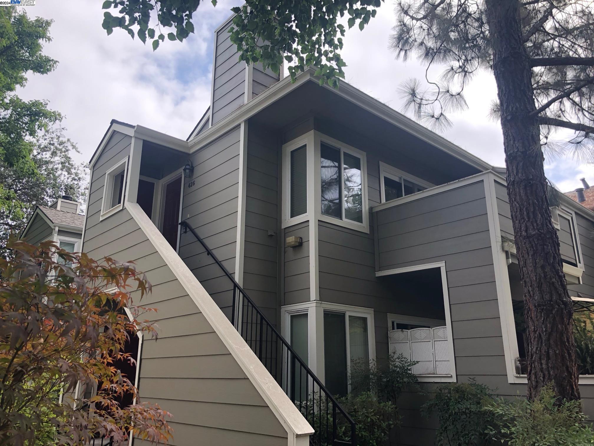 a front view of a house with a trees