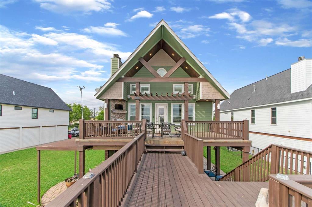 a view of house with a deck and furniture