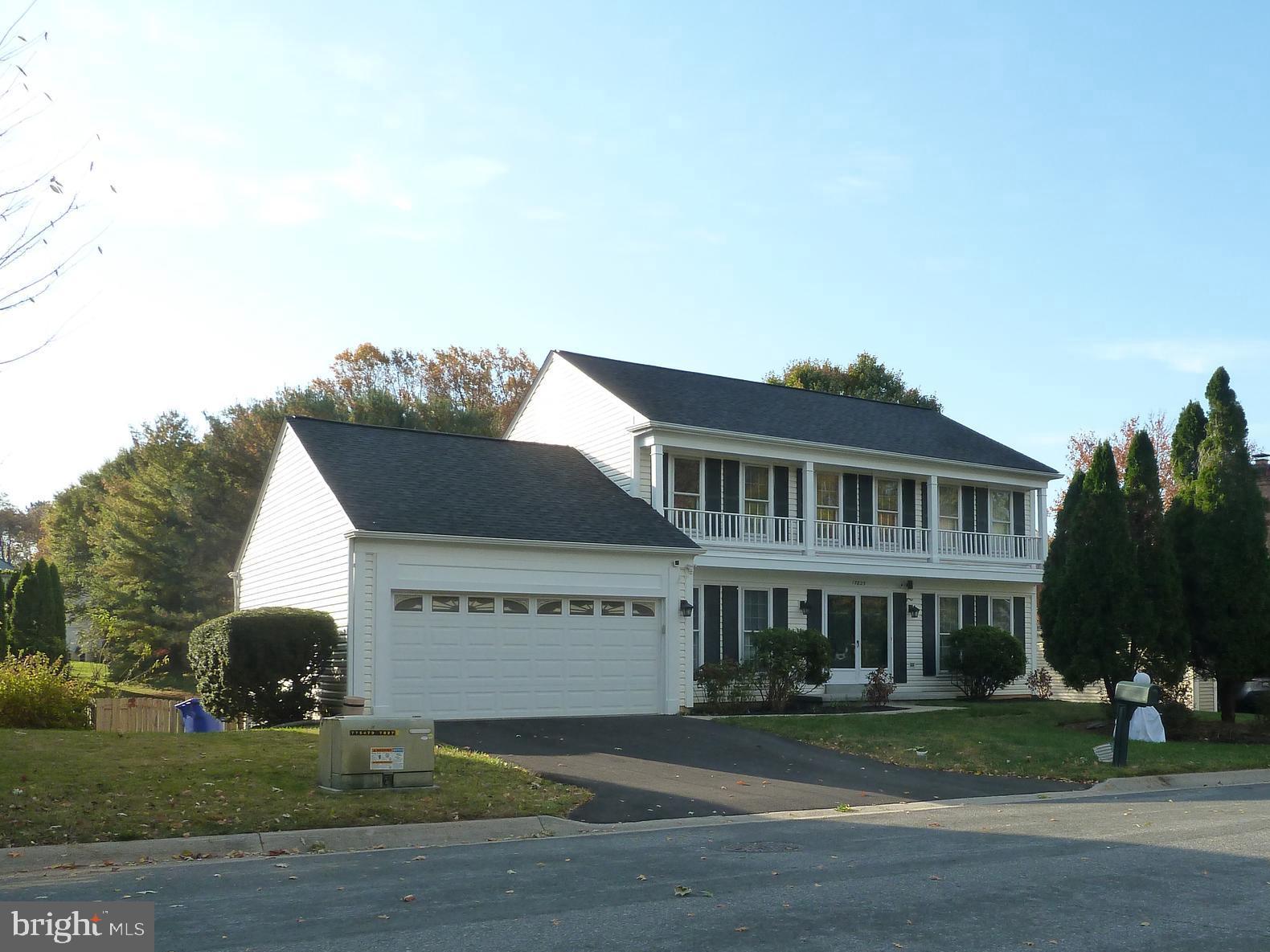 a view of a house with a yard and potted plants