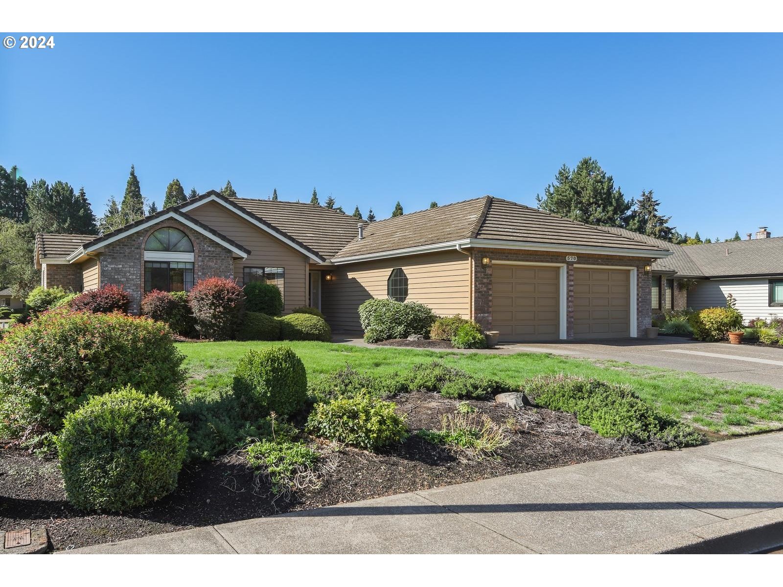 a front view of a house with a garden