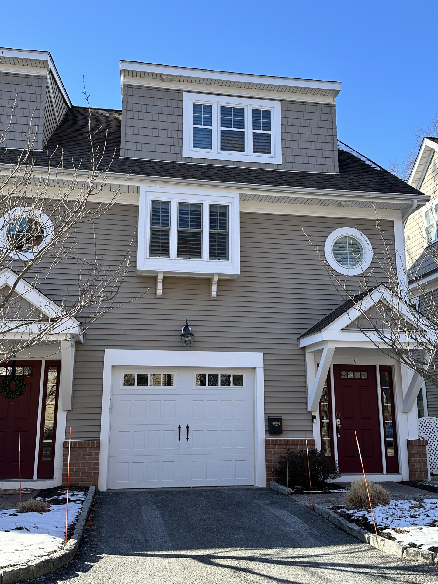 a front view of a house with parking space