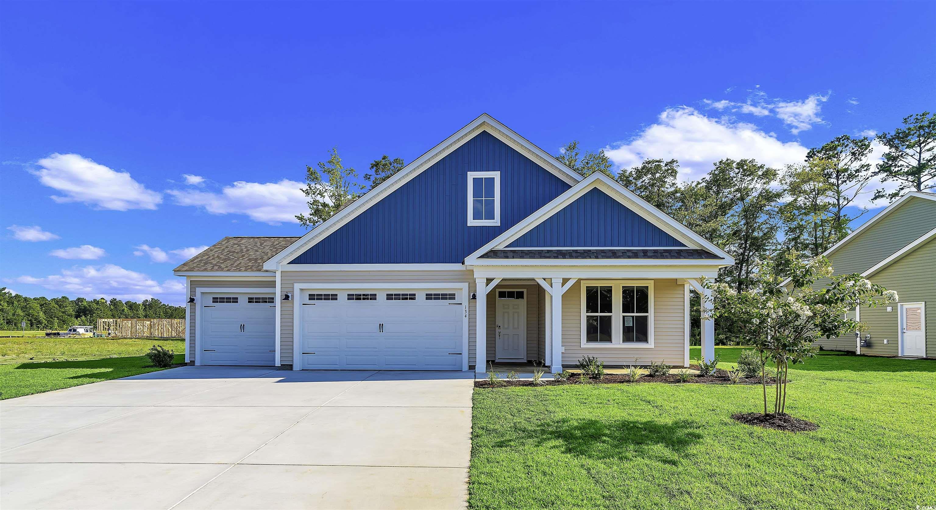 View of front of property featuring a garage and a