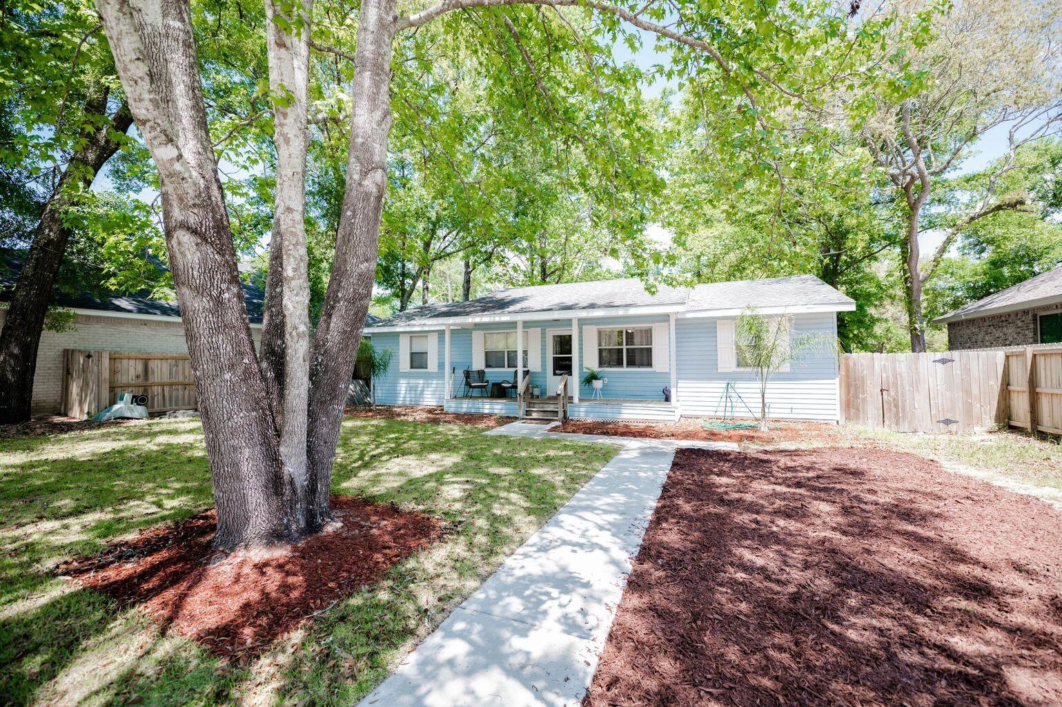 a front view of a house with yard patio and green space