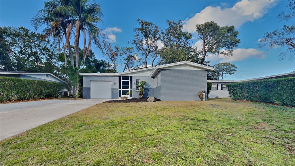 a house with a yard and a garage