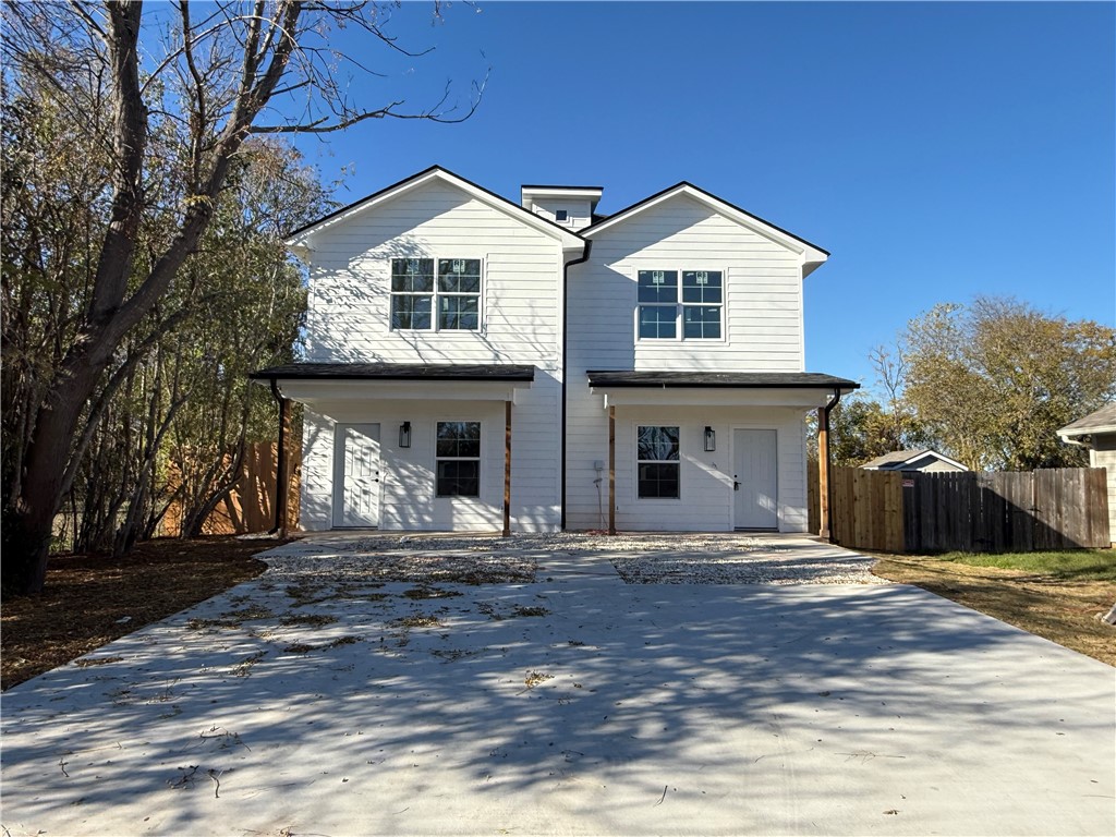 a front view of a house with yard and trees