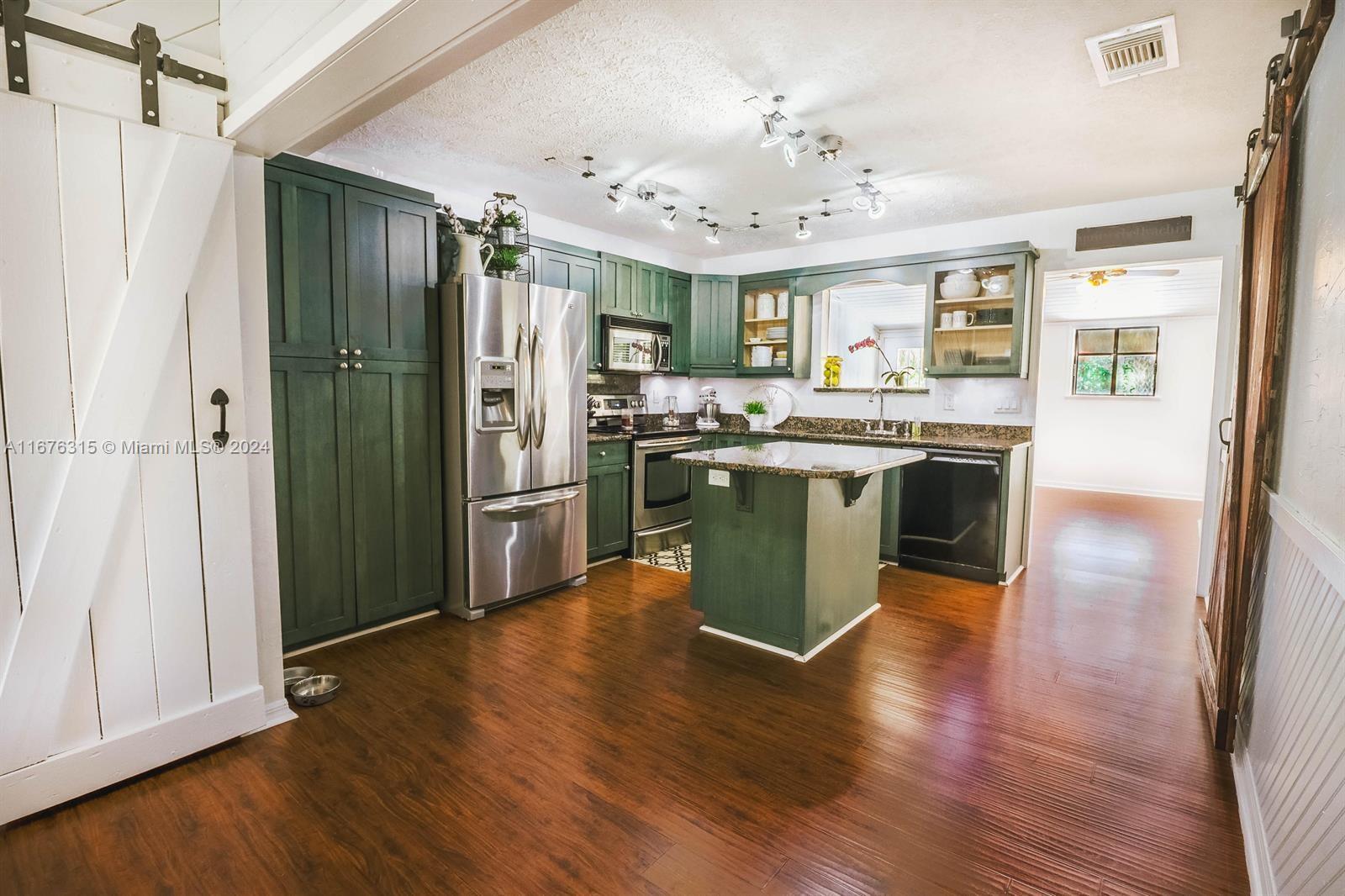 a view of kitchen with cabinets and wooden floor