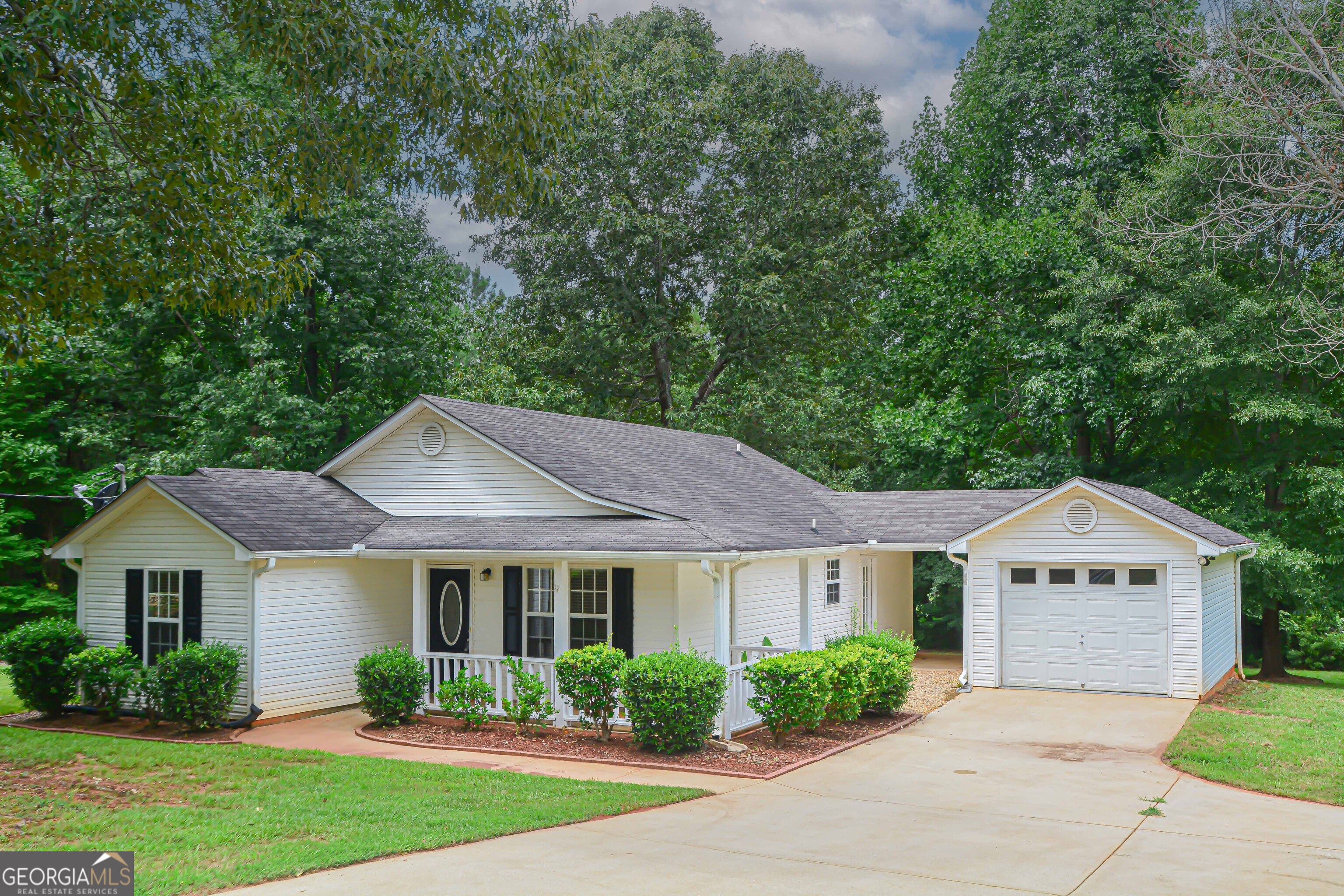 a front view of a house with garden