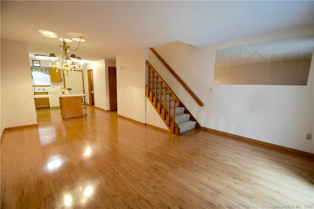 a view of an entryway with wooden floor