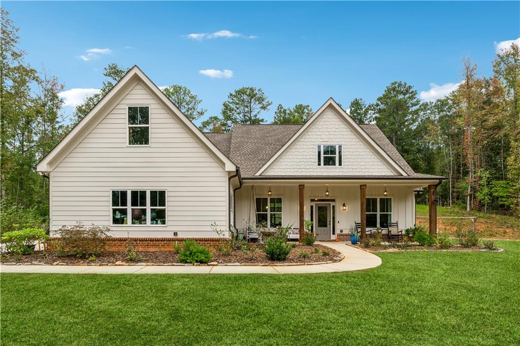 a front view of a house with a yard and porch