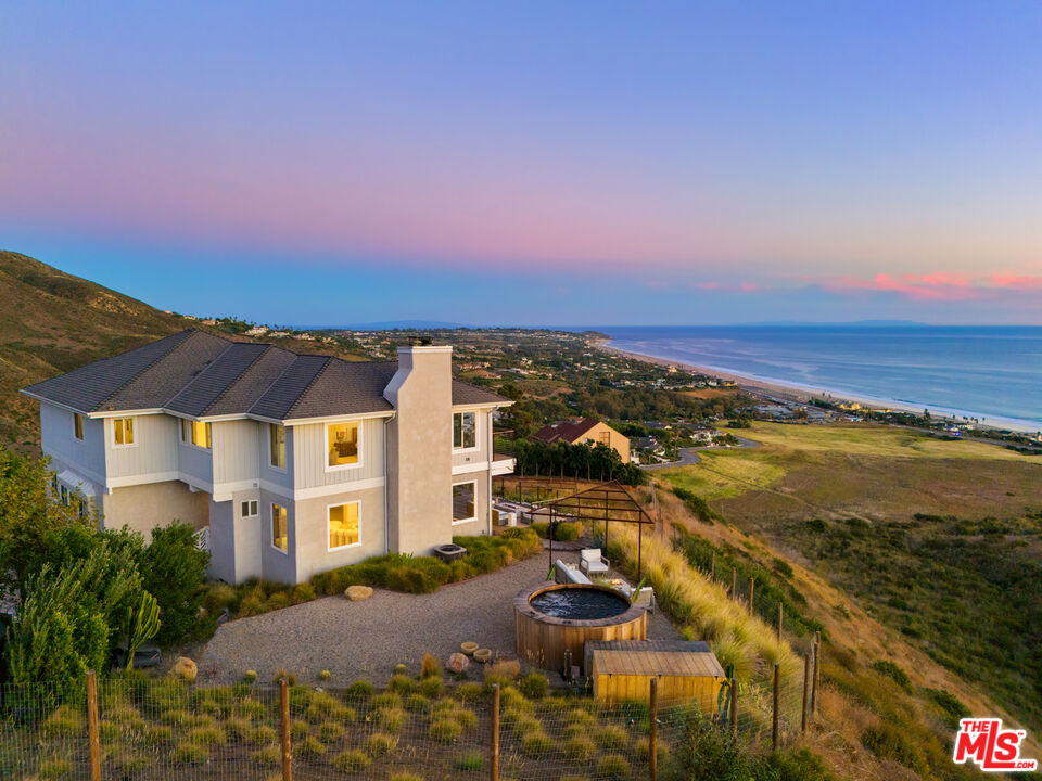 an aerial view of residential building and ocean