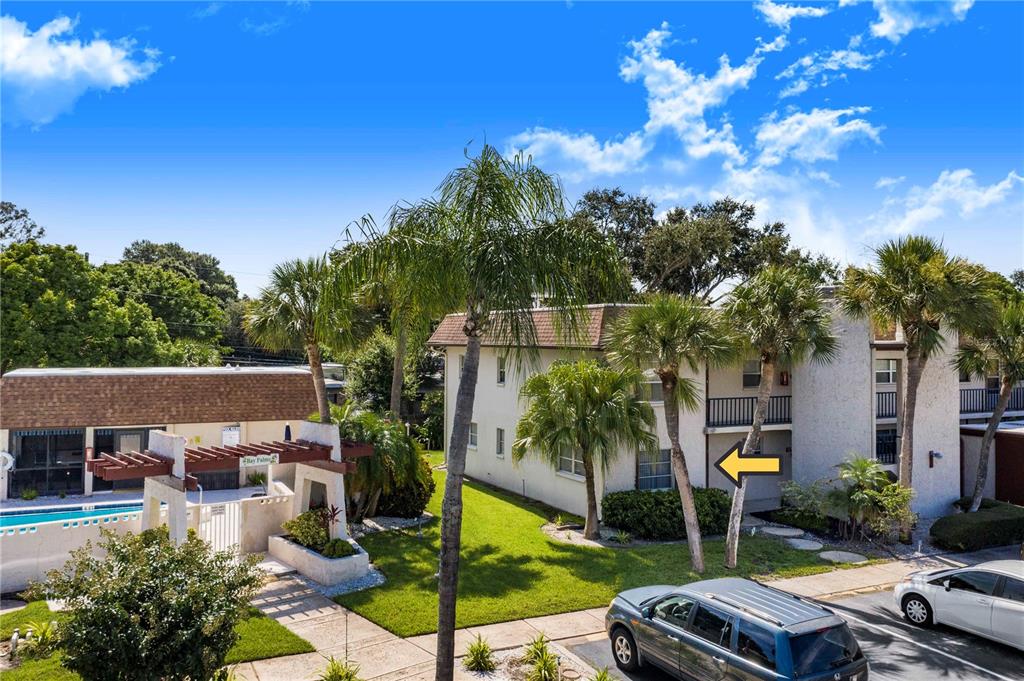 a view of backyard with swimming pool and outdoor seating