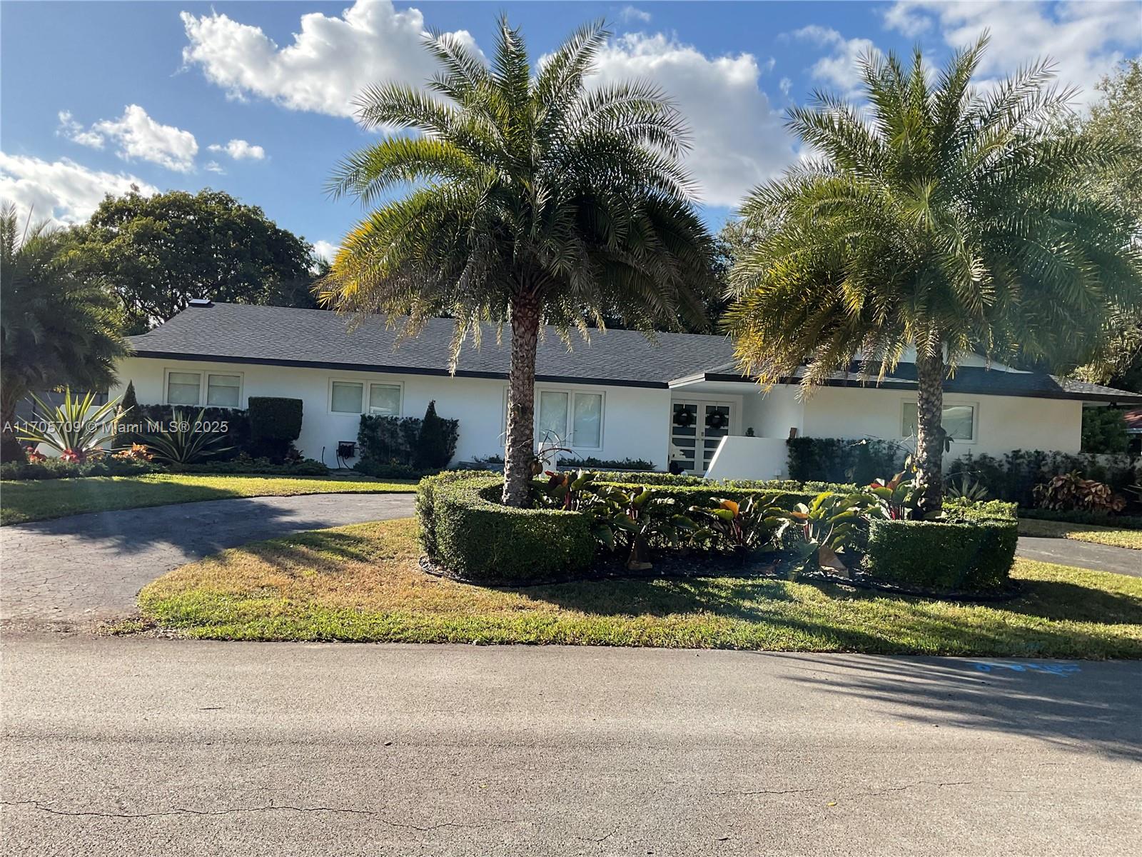 a front view of a house with swimming pool and a yard