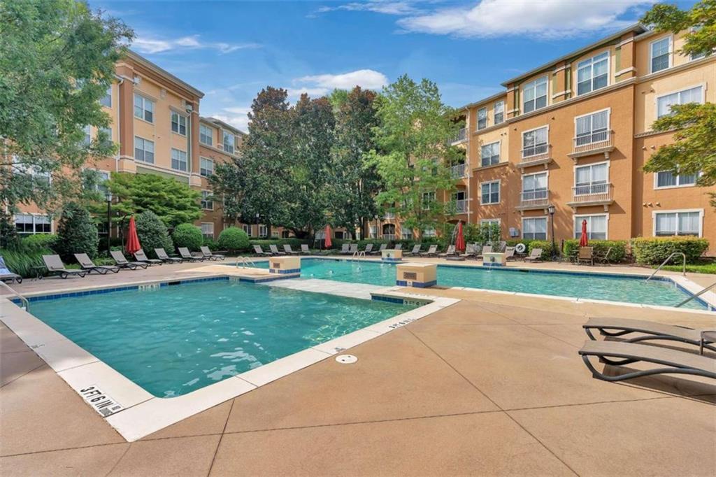 a swimming pool with outdoor seating and yard