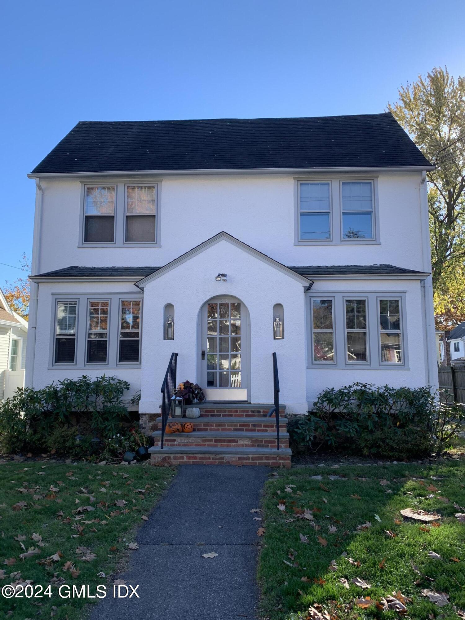 a front view of a house with a yard