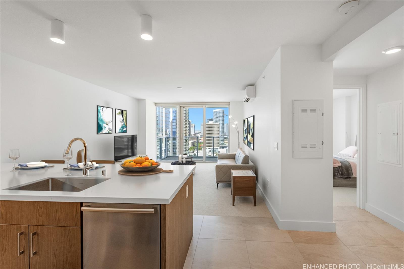 a dining room with stainless steel appliances furniture a large window and a couch