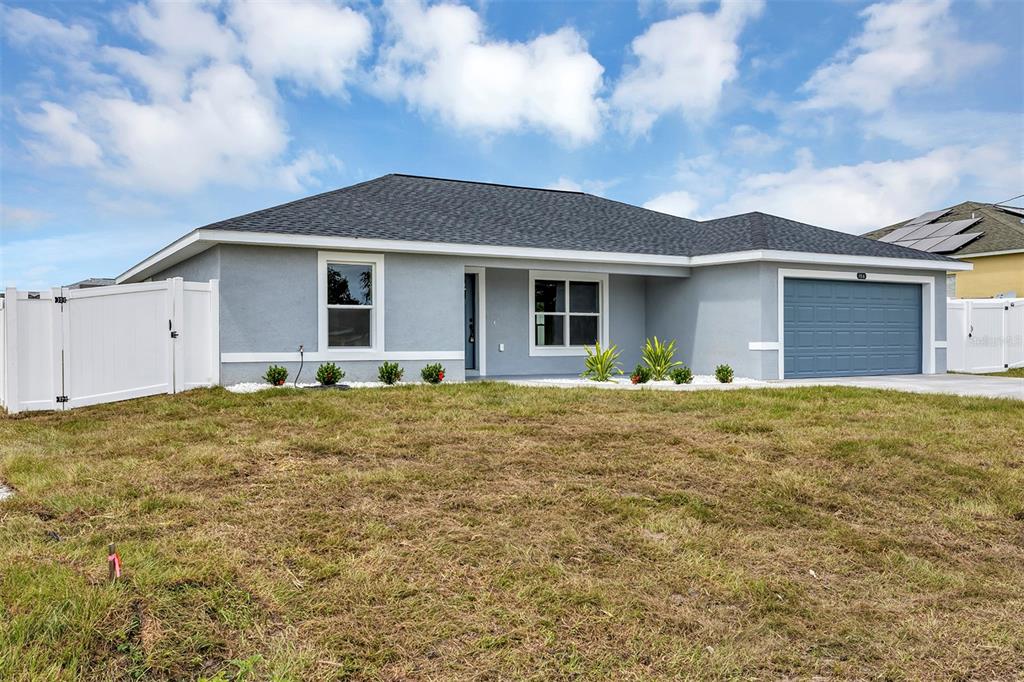 a front view of house with yard and trees