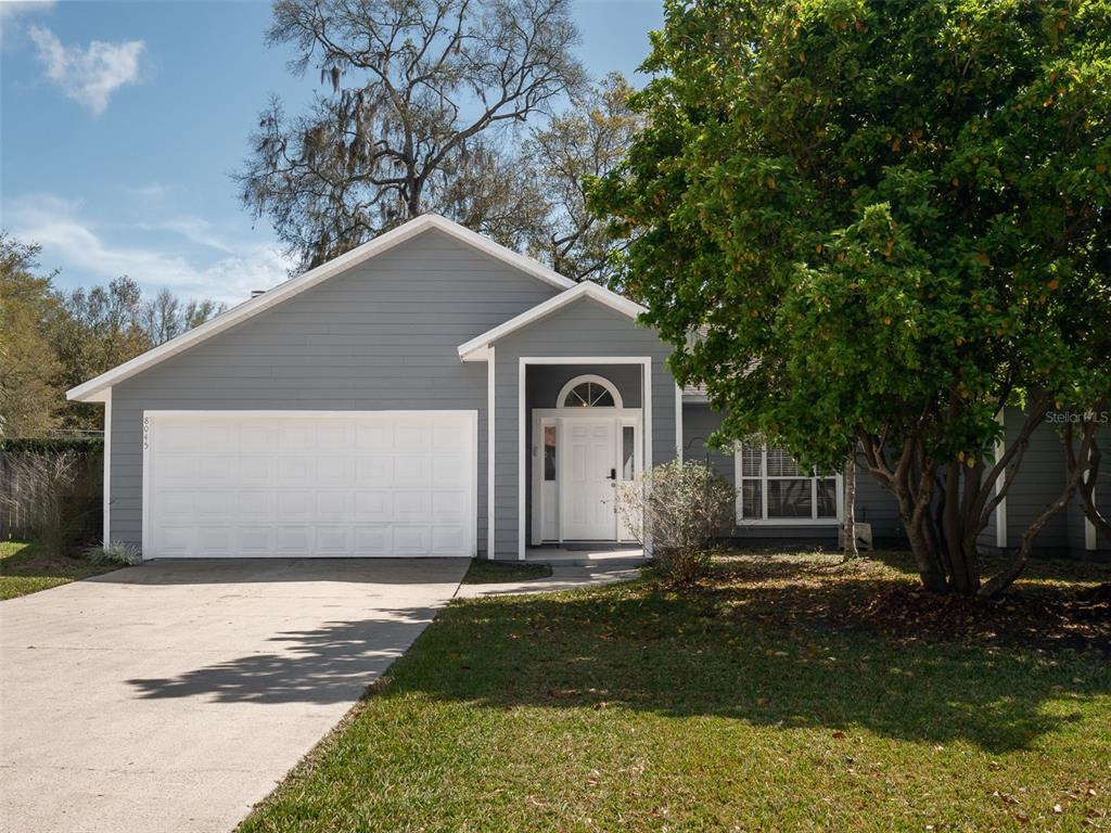 a front view of house with yard and trees