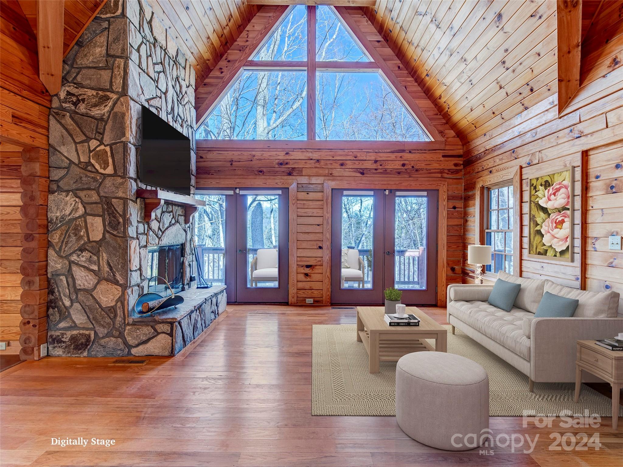 a living room with furniture a fireplace and large windows