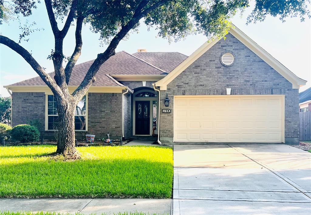 a front view of house with yard and garage