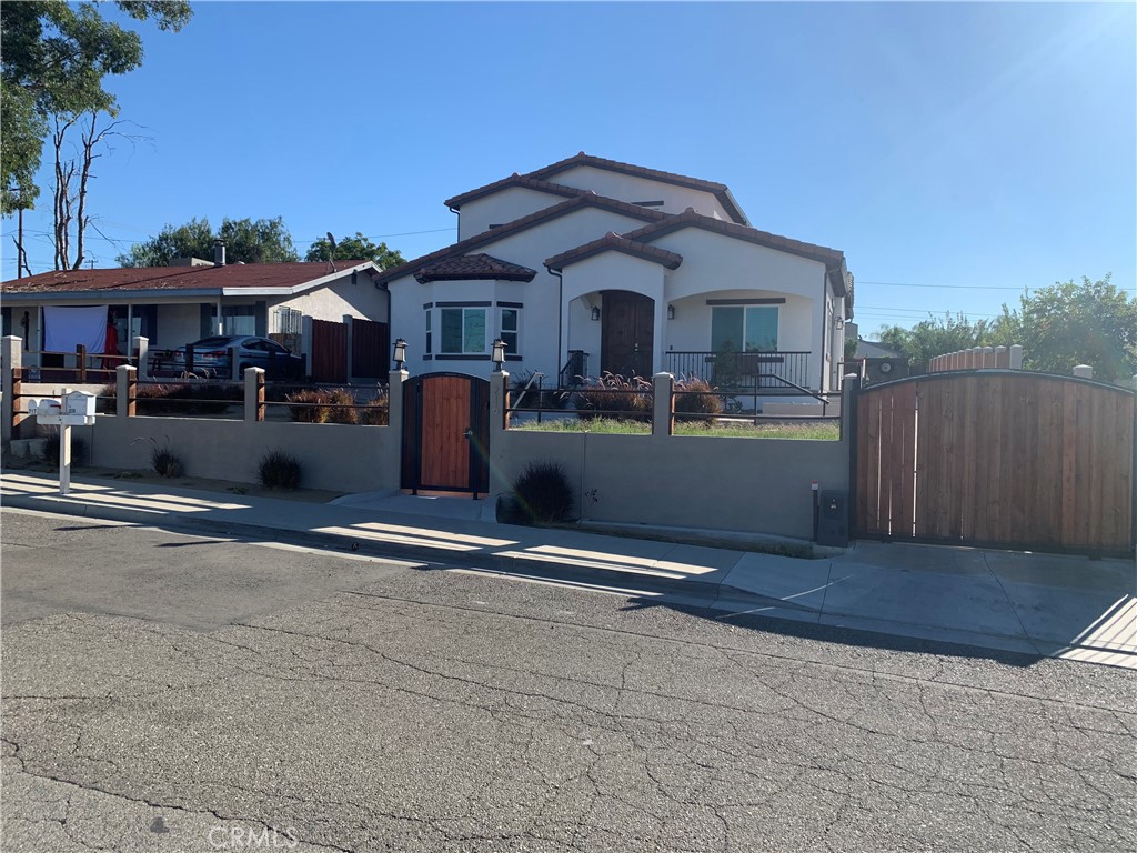 a front view of house with yard and parking