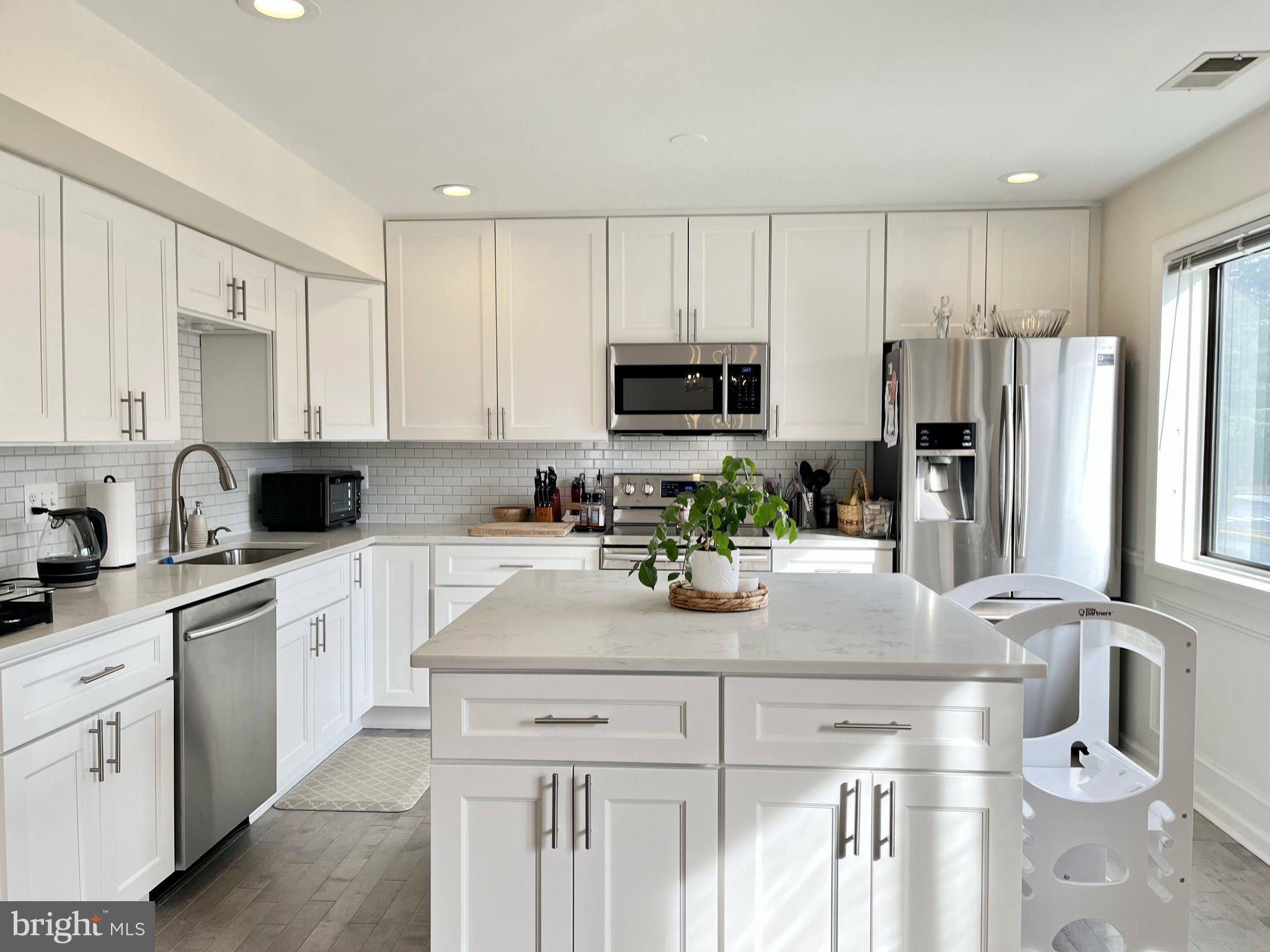 a kitchen with a sink stove and refrigerator