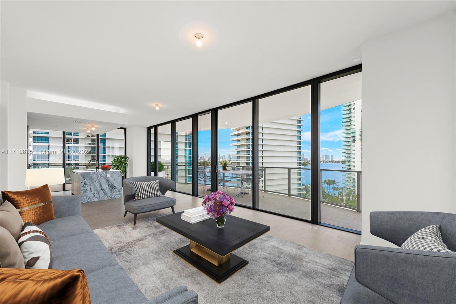 a living room with furniture and floor to ceiling window