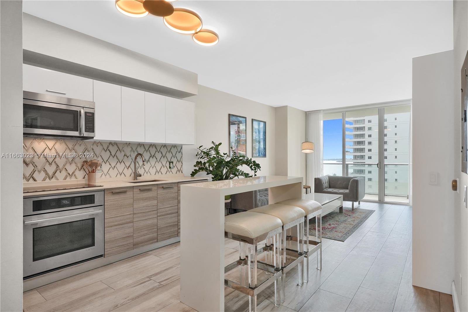 a kitchen with granite countertop white cabinets and stainless steel appliances