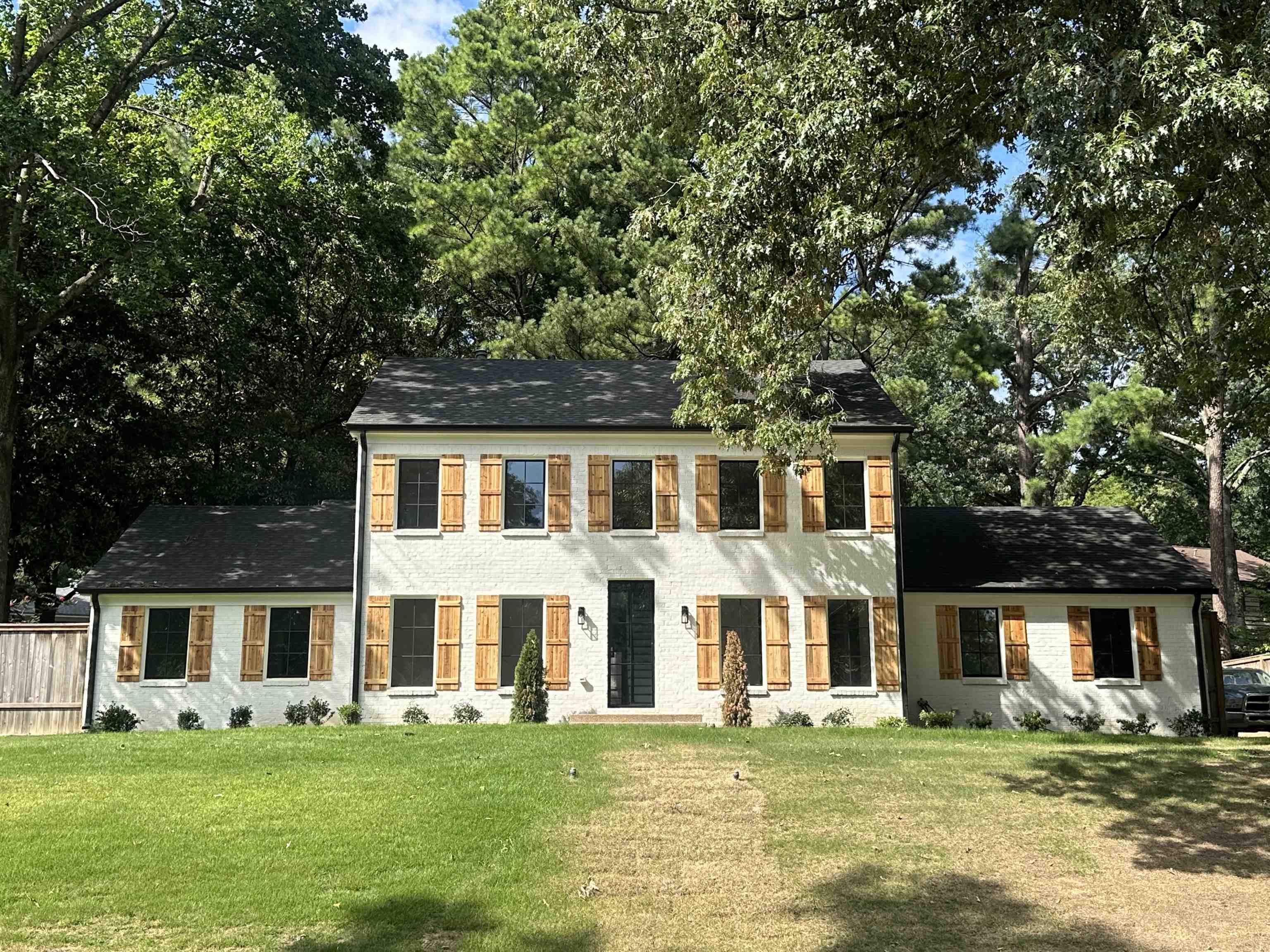 Colonial home featuring a front lawn