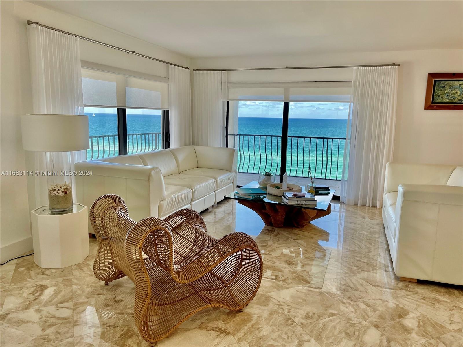 a living room with furniture and a floor to ceiling window