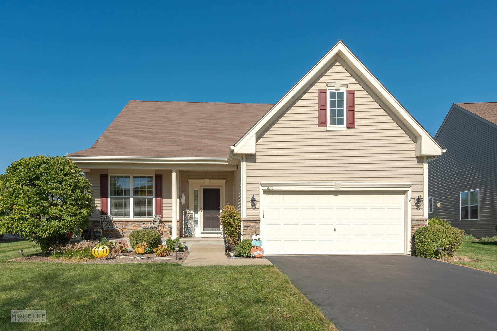 a view of a house with a yard and sitting area