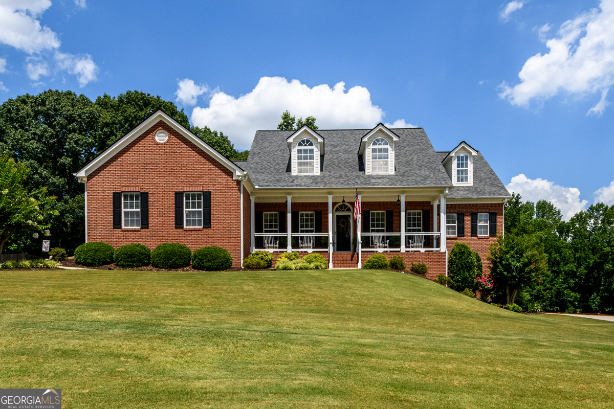 a front view of a house with garden