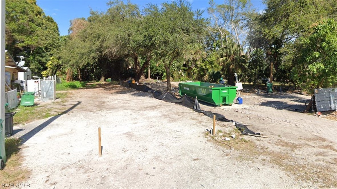 a view of a backyard with large trees