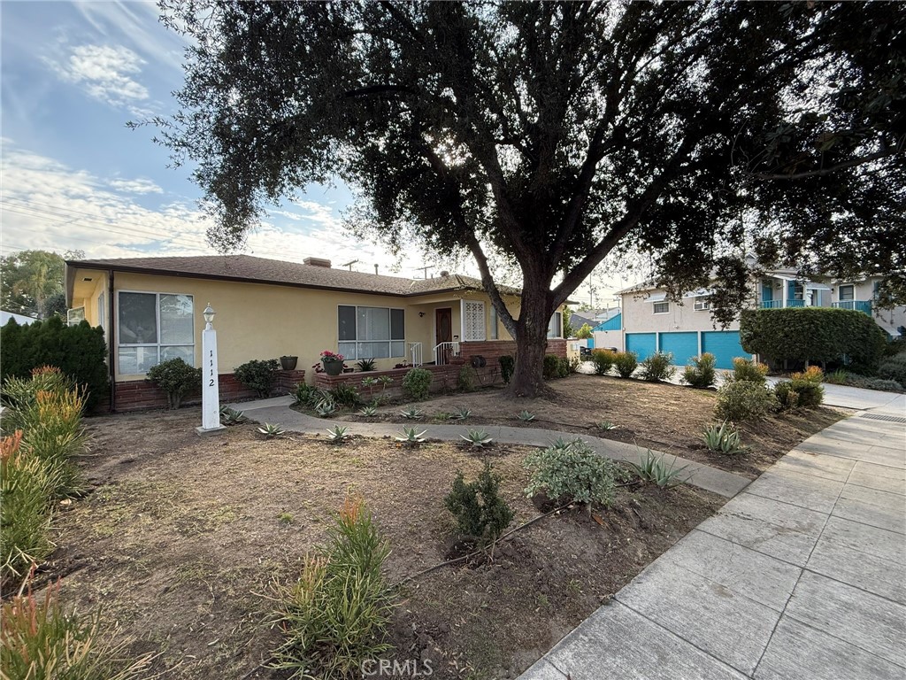 a view of a house with backyard and sitting area