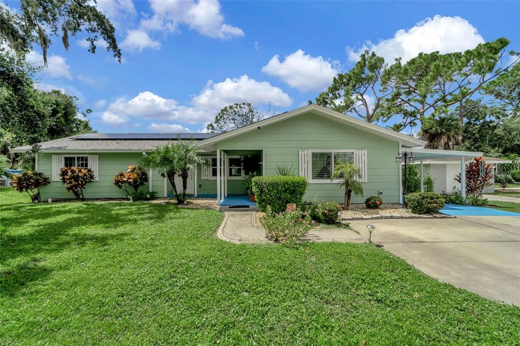 a front view of house with yard and outdoor seating