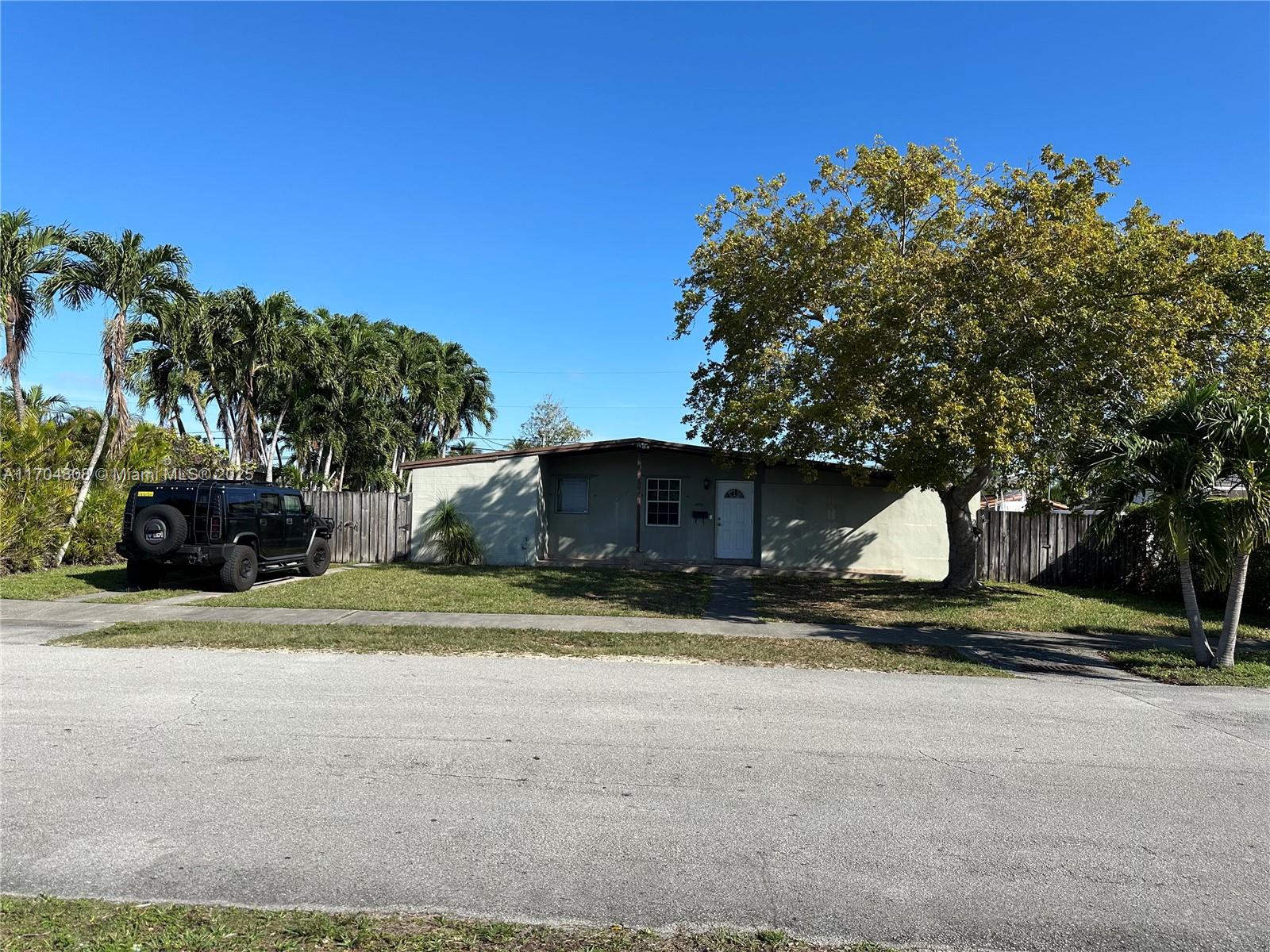 a view of a house with a yard and garage