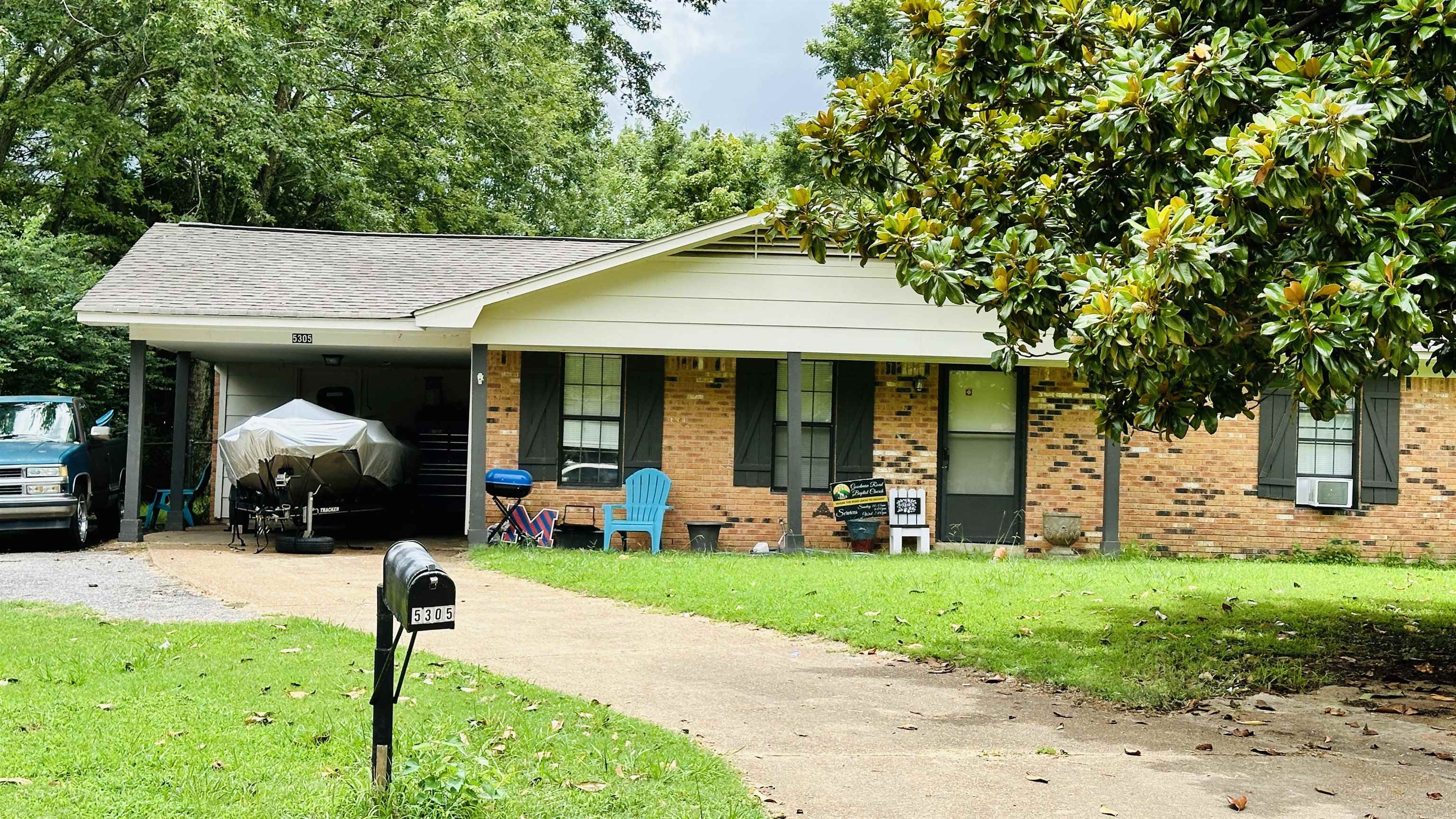 a front view of a house with garden and porch