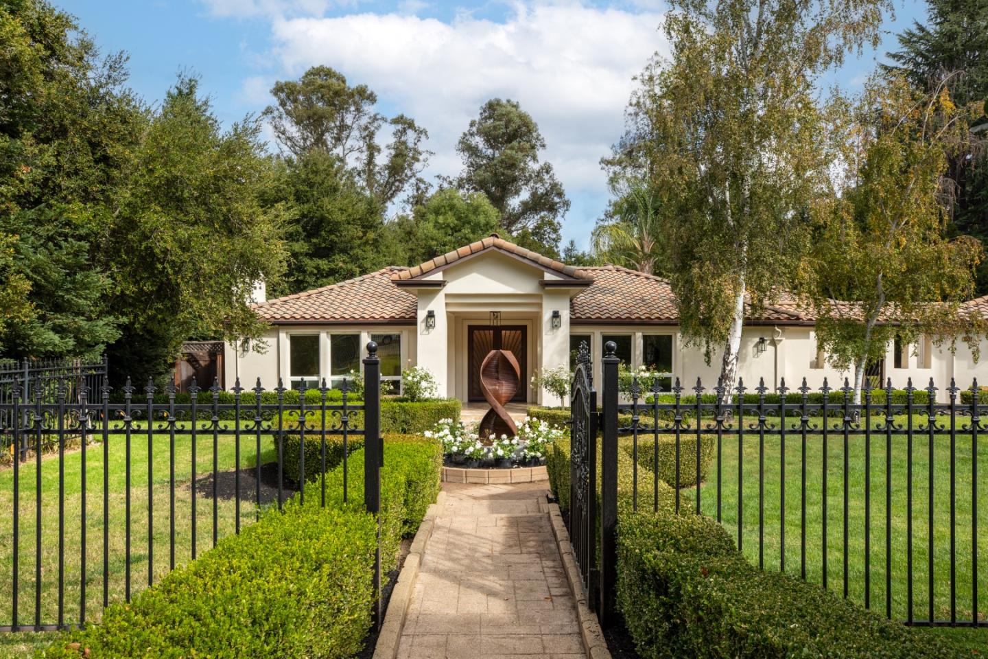 a front view of a house with a garden