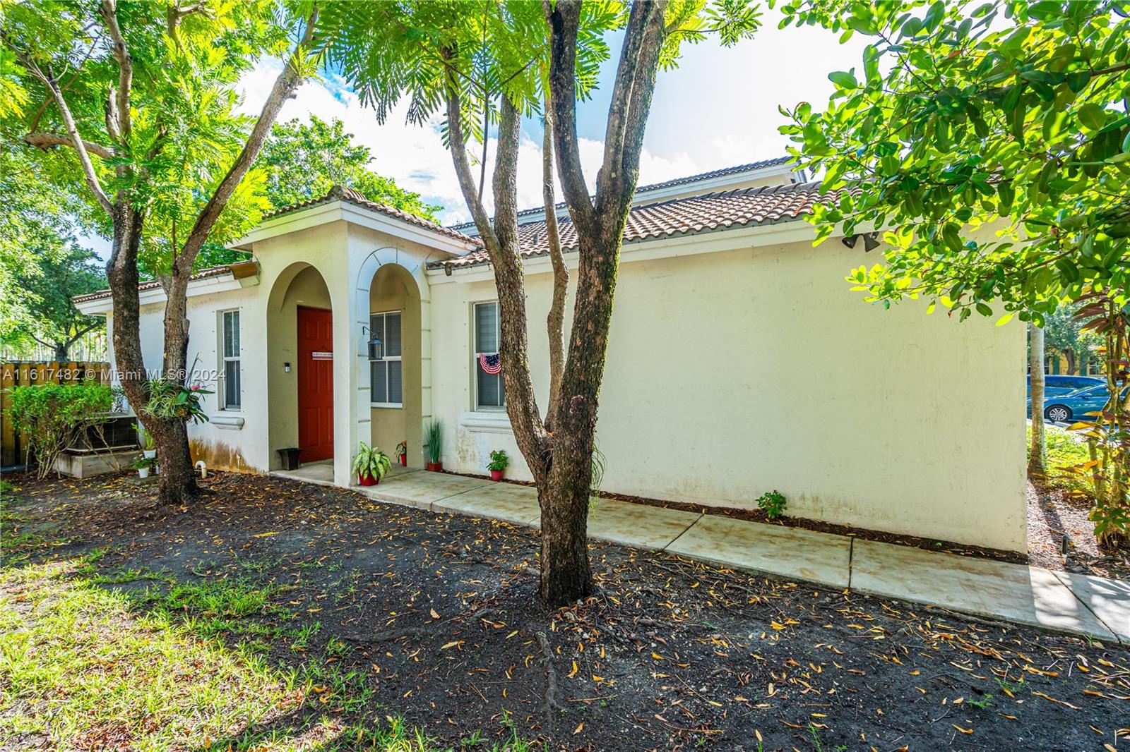 a view of a house with a tree and a yard