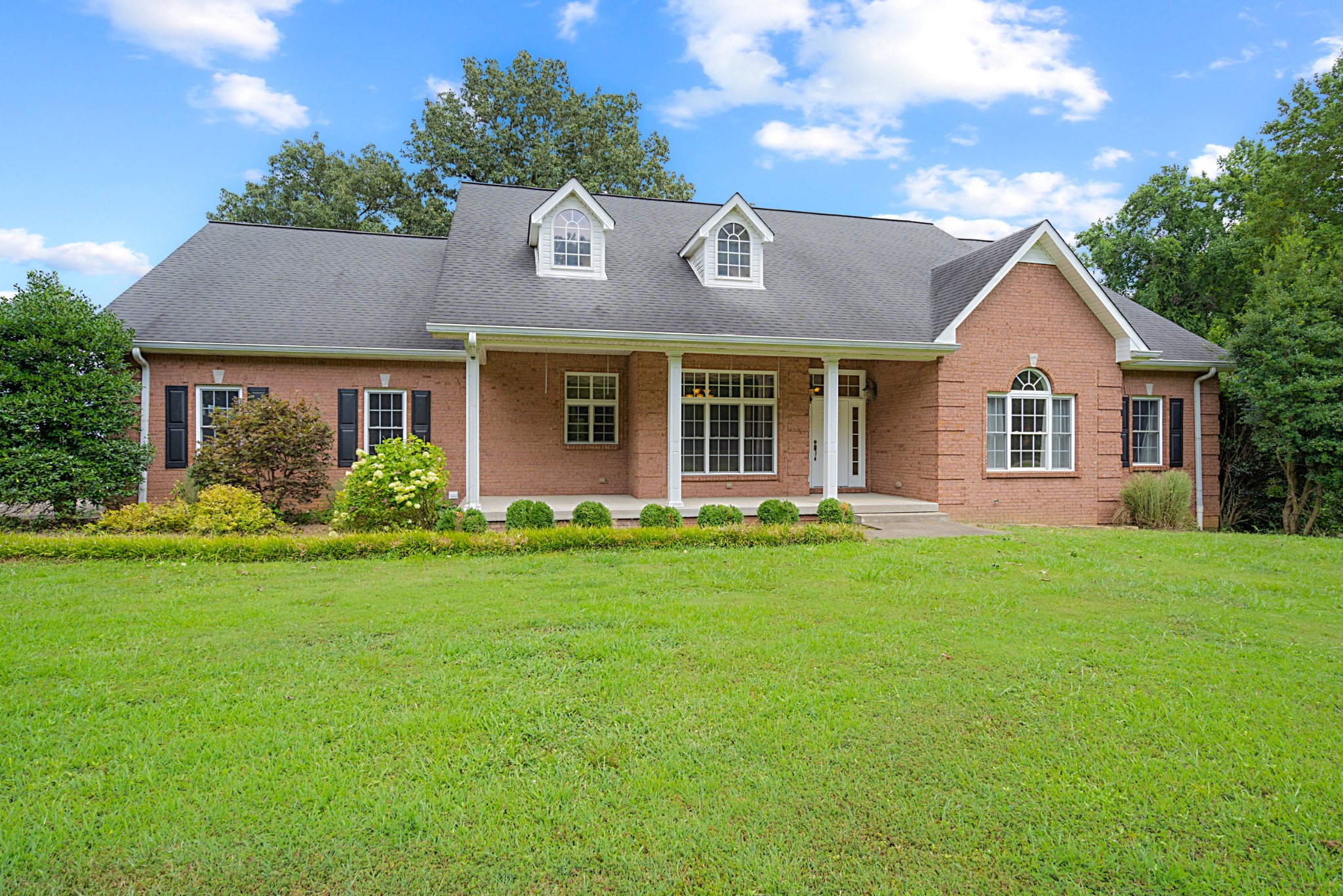 a front view of a house with garden