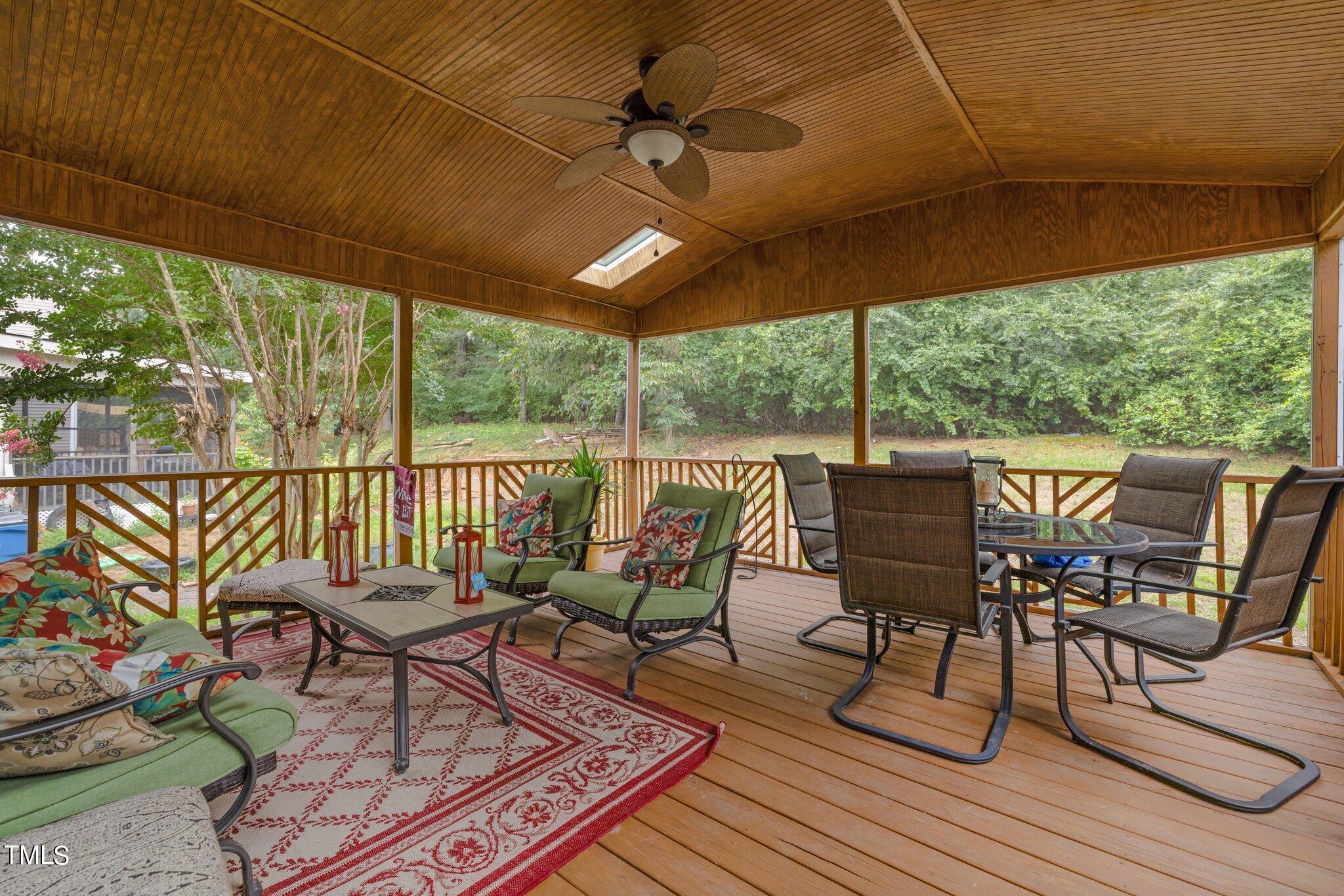 a view of a patio with table and chairs potted plants with wooden floor