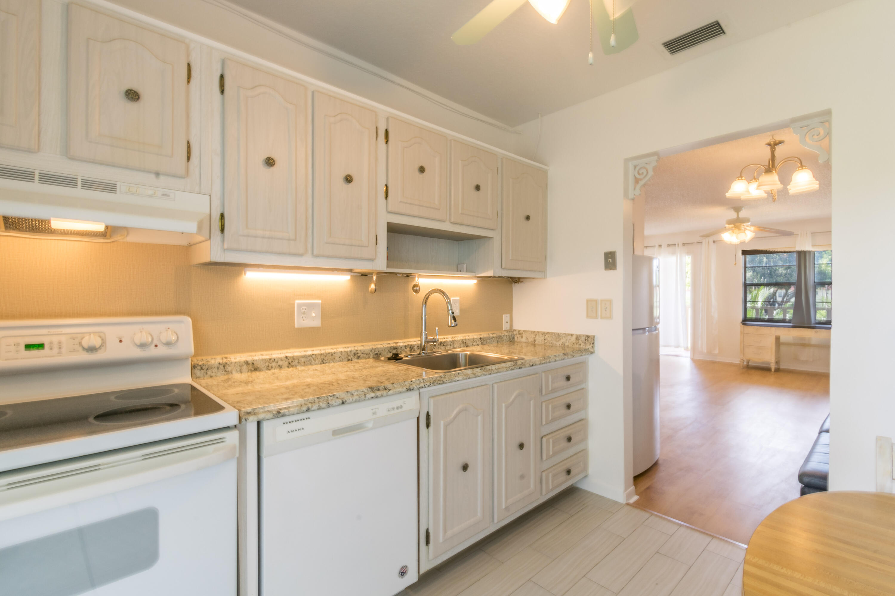 a kitchen with cabinets appliances and a counter space