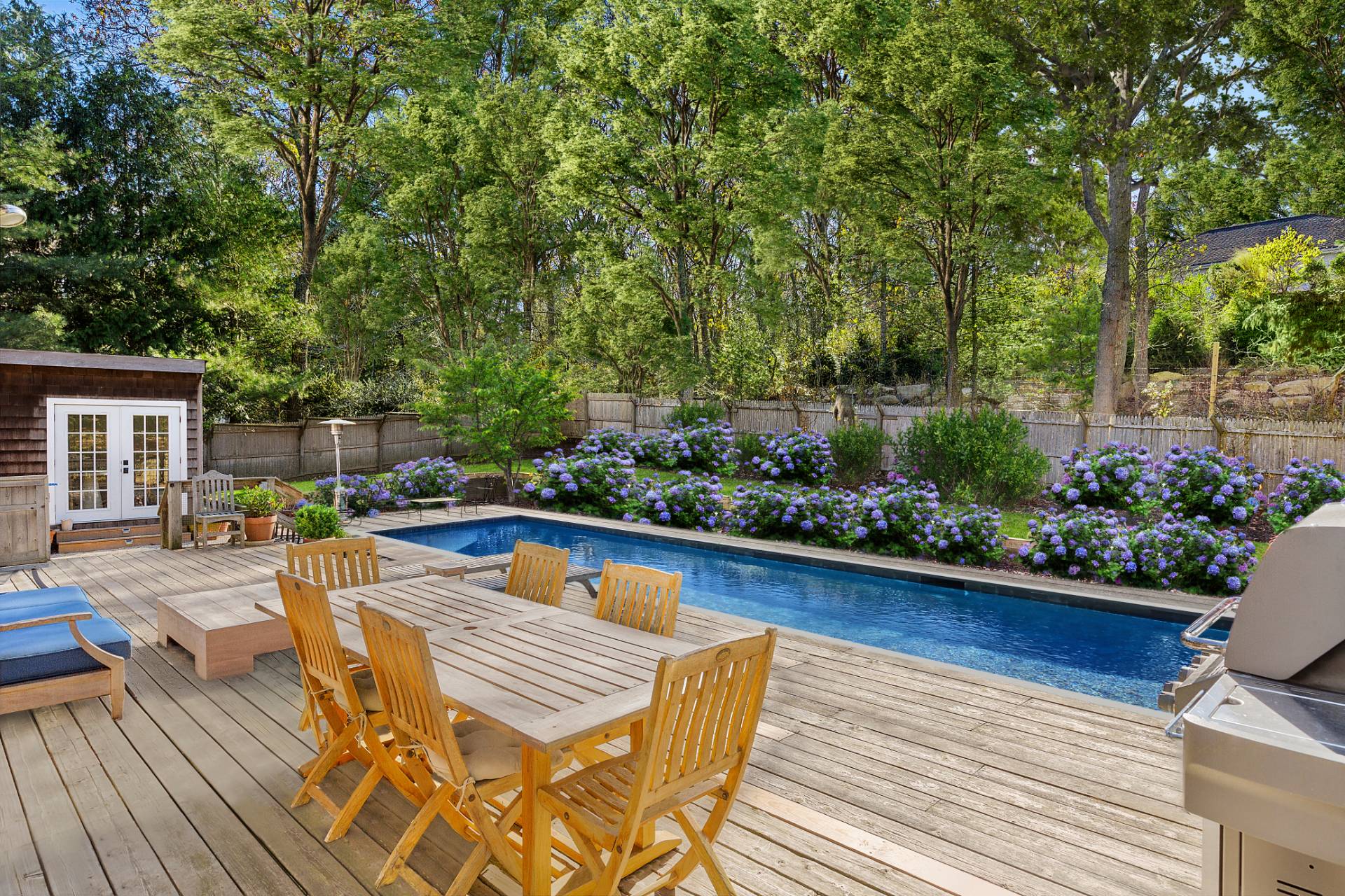 a view of swimming pool with outdoor seating and plants