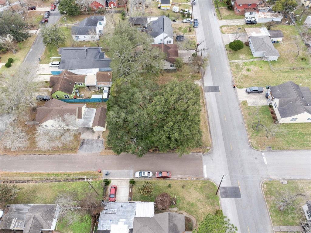 aerial view of a house with a yard and large trees