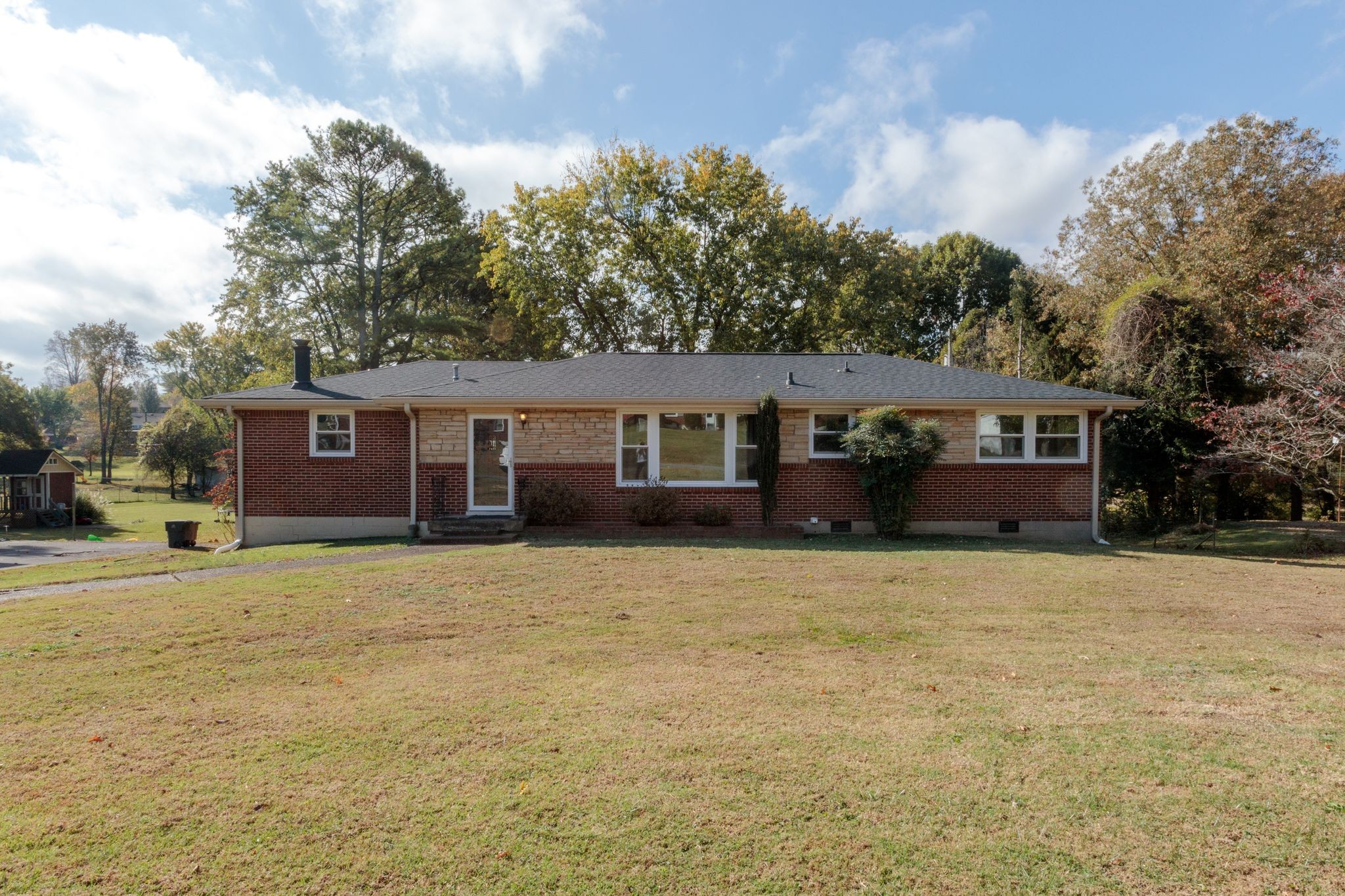 a front view of a house with a yard