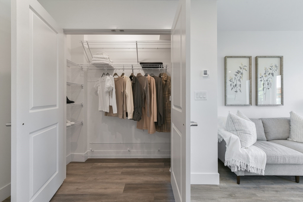 a living room with furniture and a walk in closet