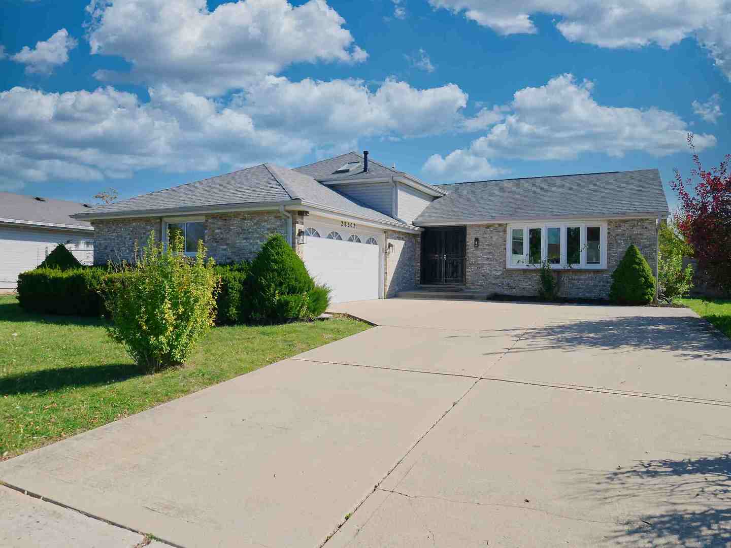 a front view of house with yard and green space